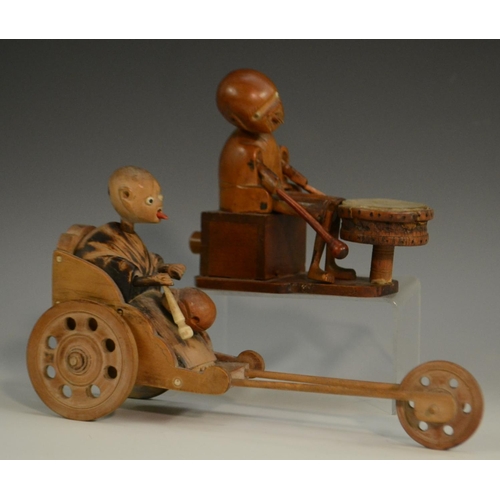 3104 - A Japanese Kobe automaton toy, as a comical figure in a carriage, the wheels animating his limbs, 20... 