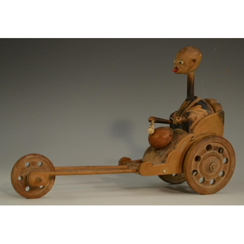 3104 - A Japanese Kobe automaton toy, as a comical figure in a carriage, the wheels animating his limbs, 20... 