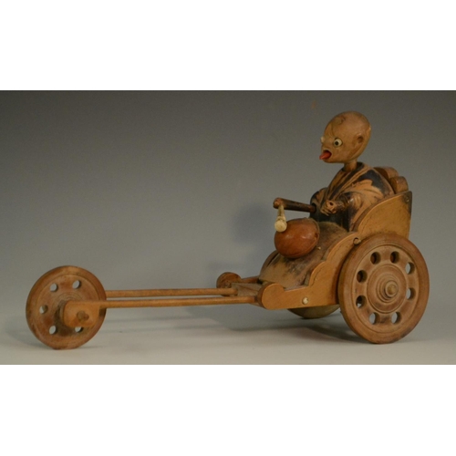 3104 - A Japanese Kobe automaton toy, as a comical figure in a carriage, the wheels animating his limbs, 20... 