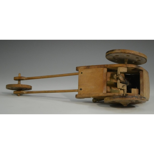 3104 - A Japanese Kobe automaton toy, as a comical figure in a carriage, the wheels animating his limbs, 20... 