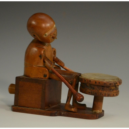 3104 - A Japanese Kobe automaton toy, as a comical figure in a carriage, the wheels animating his limbs, 20... 