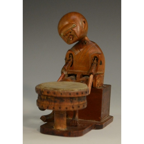 3104 - A Japanese Kobe automaton toy, as a comical figure in a carriage, the wheels animating his limbs, 20... 