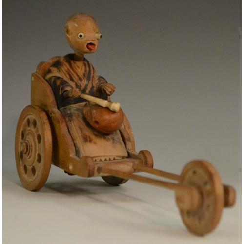 3104 - A Japanese Kobe automaton toy, as a comical figure in a carriage, the wheels animating his limbs, 20... 