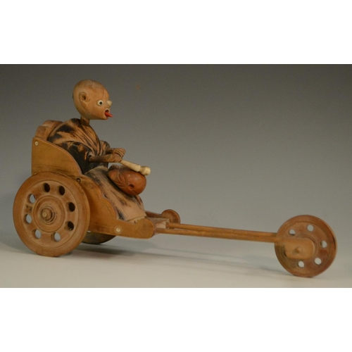 3104 - A Japanese Kobe automaton toy, as a comical figure in a carriage, the wheels animating his limbs, 20... 