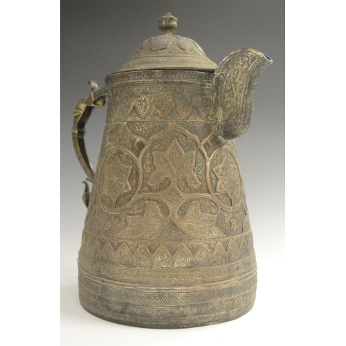 3108 - A Kashmiri copper flagon, profusely chased in the Persian taste with stylised lotus, flowering meand... 