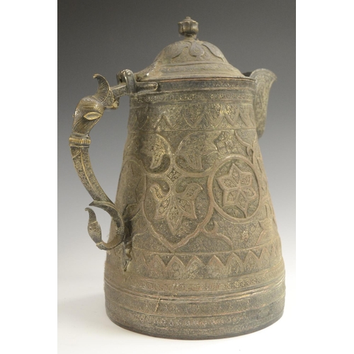 3108 - A Kashmiri copper flagon, profusely chased in the Persian taste with stylised lotus, flowering meand... 