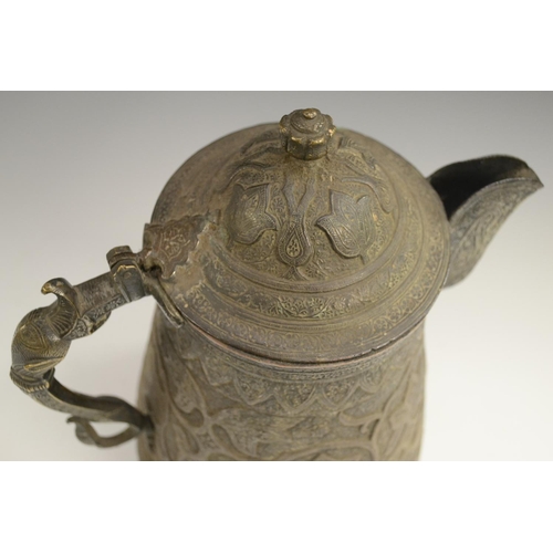 3108 - A Kashmiri copper flagon, profusely chased in the Persian taste with stylised lotus, flowering meand... 