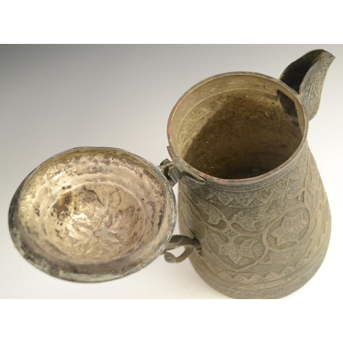 3108 - A Kashmiri copper flagon, profusely chased in the Persian taste with stylised lotus, flowering meand... 