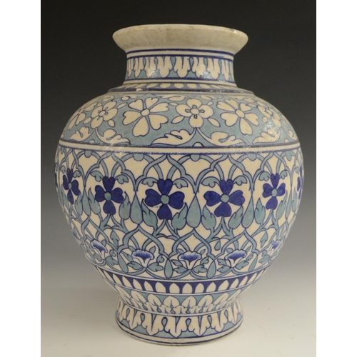 3123 - A Middle-Eastern ovoid vase, decorated in the Persian taste in tones of blue and turquoise with Izni... 