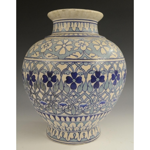 3123 - A Middle-Eastern ovoid vase, decorated in the Persian taste in tones of blue and turquoise with Izni... 