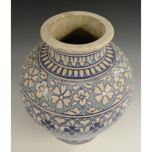 3123 - A Middle-Eastern ovoid vase, decorated in the Persian taste in tones of blue and turquoise with Izni... 