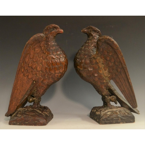 3127 - A pair of 19th century oak country house newel post crestings, each well carved as a falcon, the bea... 