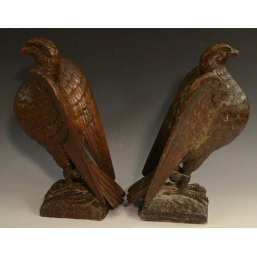 3127 - A pair of 19th century oak country house newel post crestings, each well carved as a falcon, the bea... 