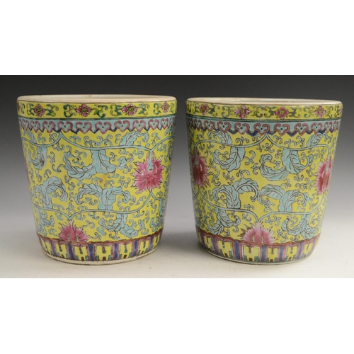 3129 - A pair of Chinese tapered cylindrical jardinieres, brightly painted with chrysanthemums, lotus and s... 