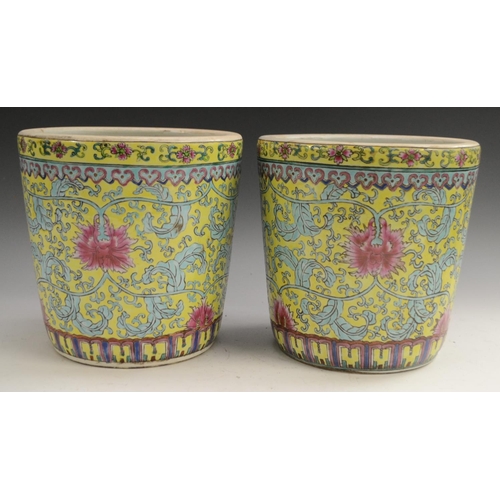 3129 - A pair of Chinese tapered cylindrical jardinieres, brightly painted with chrysanthemums, lotus and s... 