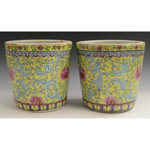 3129 - A pair of Chinese tapered cylindrical jardinieres, brightly painted with chrysanthemums, lotus and s... 