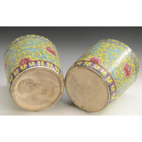 3129 - A pair of Chinese tapered cylindrical jardinieres, brightly painted with chrysanthemums, lotus and s... 