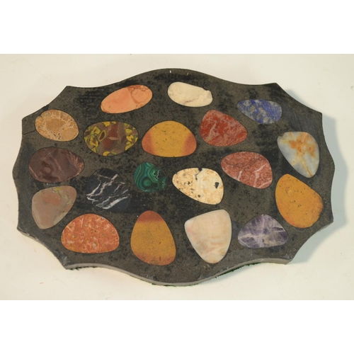 3137 - A pietra dura shaped oval desk weight, inlaid with pebble shaped reserves of malachite, amethyst qua... 