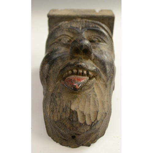 3138 - A post-Medieval oak corbel grotesque, carved as a bearded man, his tongue protruding, 14cm long; ano... 