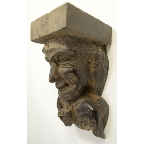 3138 - A post-Medieval oak corbel grotesque, carved as a bearded man, his tongue protruding, 14cm long; ano... 