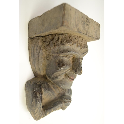 3138 - A post-Medieval oak corbel grotesque, carved as a bearded man, his tongue protruding, 14cm long; ano... 