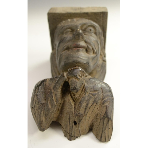 3138 - A post-Medieval oak corbel grotesque, carved as a bearded man, his tongue protruding, 14cm long; ano... 