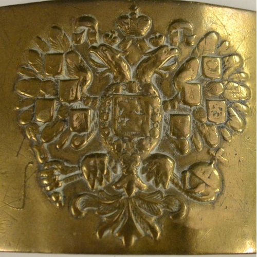 3139 - A Russian brass belt buckle, probably military, chased with the Imperial double-headed eagle, Cyrill... 