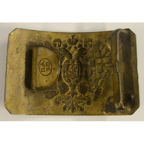 3139 - A Russian brass belt buckle, probably military, chased with the Imperial double-headed eagle, Cyrill... 