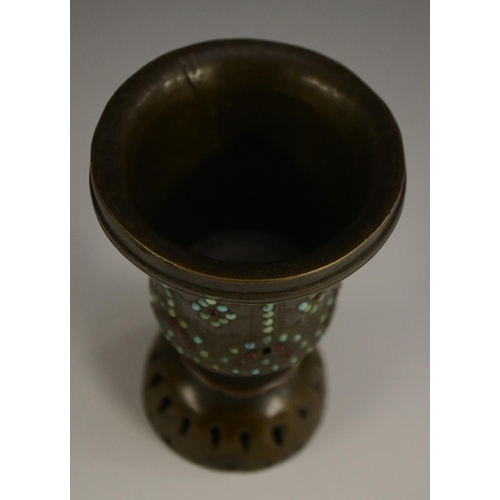 3149 - A Tibetan bronze chalice, chased with strapwork and applied with cabochons, 10cm high