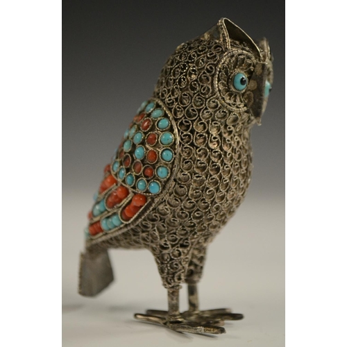 3150 - A Tibetan silver model of an owl, applied with turquoise and coral cabochons, 6.5cm high