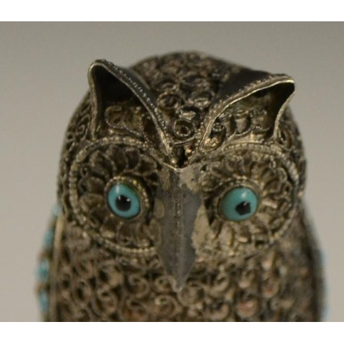 3150 - A Tibetan silver model of an owl, applied with turquoise and coral cabochons, 6.5cm high