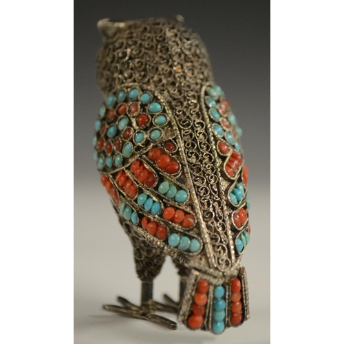 3150 - A Tibetan silver model of an owl, applied with turquoise and coral cabochons, 6.5cm high