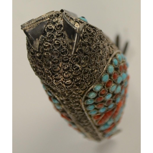 3150 - A Tibetan silver model of an owl, applied with turquoise and coral cabochons, 6.5cm high