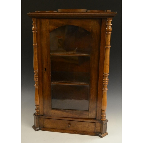 3158 - A Victorian walnut table top display cabinet, serpentine caddy top above an arched glazed door flank... 