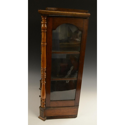 3158 - A Victorian walnut table top display cabinet, serpentine caddy top above an arched glazed door flank... 