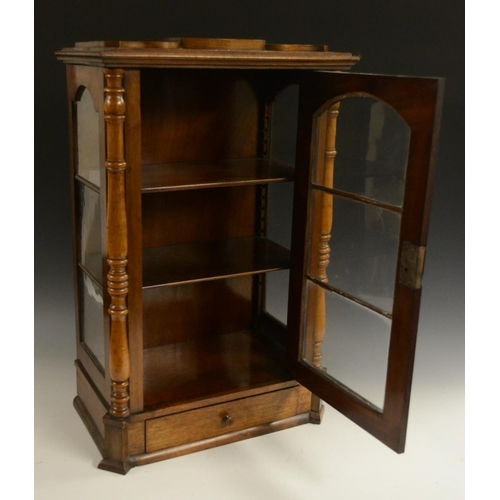 3158 - A Victorian walnut table top display cabinet, serpentine caddy top above an arched glazed door flank... 