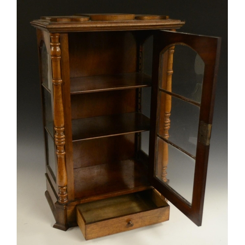 3158 - A Victorian walnut table top display cabinet, serpentine caddy top above an arched glazed door flank... 