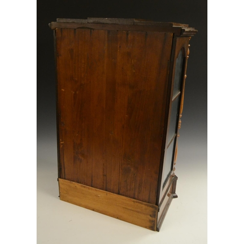 3158 - A Victorian walnut table top display cabinet, serpentine caddy top above an arched glazed door flank... 