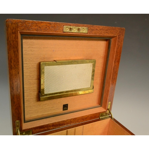 3160 - A walnut cigar humidor, by Dunhill, London, hinged quarter veneered cover, containing a part box of ... 