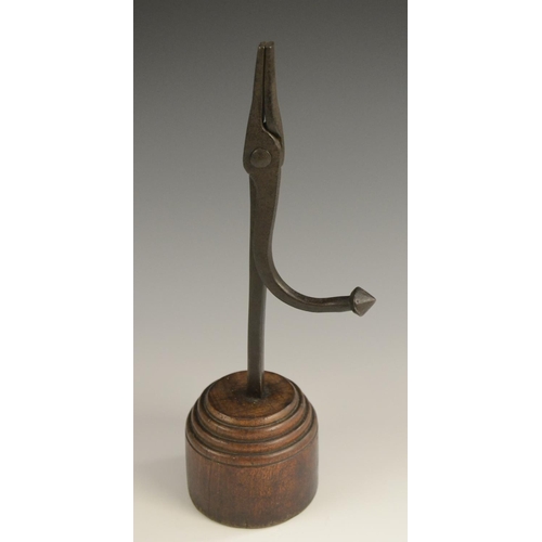 3162 - A wrought iron nip rushlight holder, stepped circular hardwood base, 27.5cm high