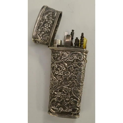 3168 - An 18th century silver-coloured metal tapered rectangular etui, chased overall in the Rococo taste w... 