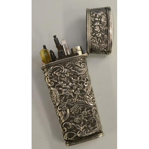 3168 - An 18th century silver-coloured metal tapered rectangular etui, chased overall in the Rococo taste w... 