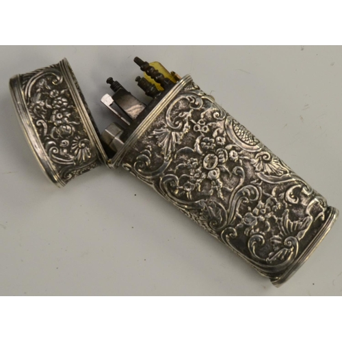 3168 - An 18th century silver-coloured metal tapered rectangular etui, chased overall in the Rococo taste w... 