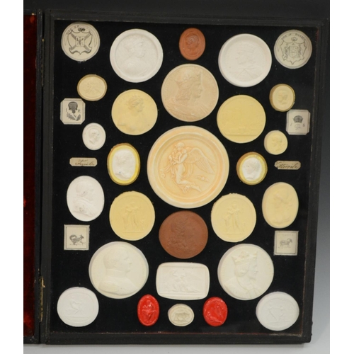 3171 - An arrangement of plaster intaglios, various Classical Grand Tour subjects, mounted in a tooled moro... 