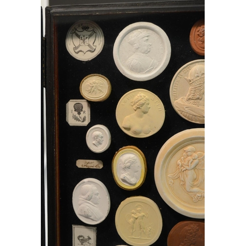 3171 - An arrangement of plaster intaglios, various Classical Grand Tour subjects, mounted in a tooled moro... 