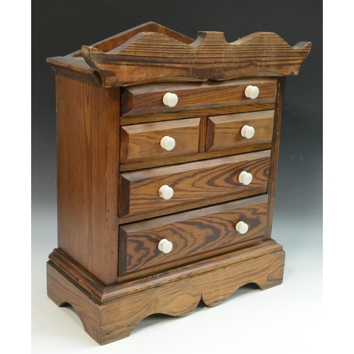 3156 - A Victorian pitch pine miniature chest of drawers, shaped cresting and lift-off cover above one long... 