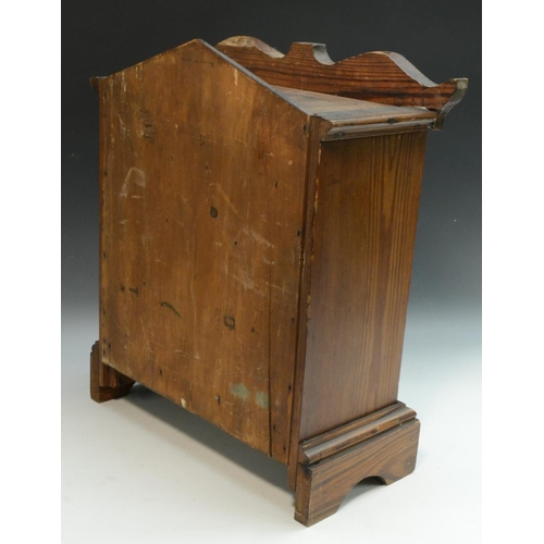 3156 - A Victorian pitch pine miniature chest of drawers, shaped cresting and lift-off cover above one long... 