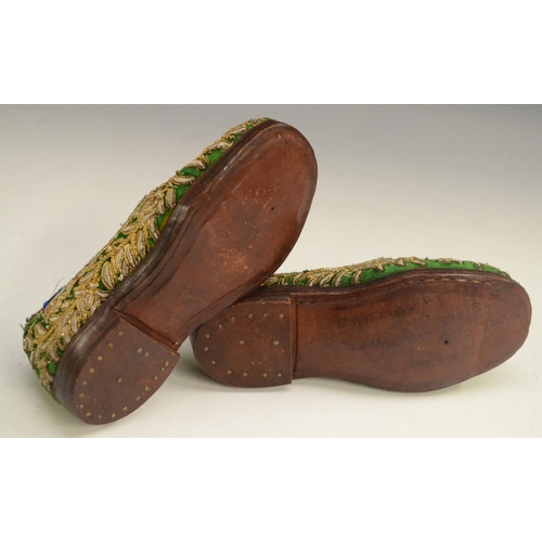 3080A - A pair of Ottoman child's shoes, embroidered and applied with gilt and silvered threads on an emeral... 