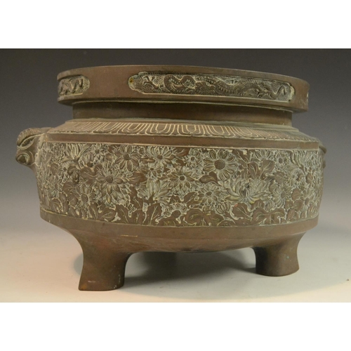 3112 - A large Chinese bronze ding censer, cast in relief with bands of lotus, flowerheads and dragons, tem... 