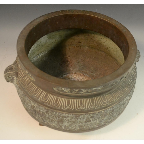 3112 - A large Chinese bronze ding censer, cast in relief with bands of lotus, flowerheads and dragons, tem... 